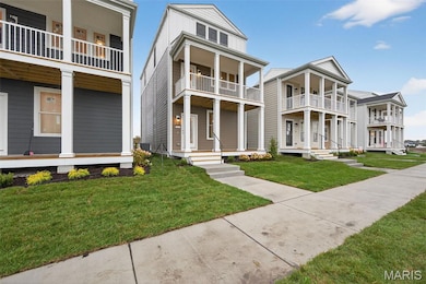 View of front of home featuring covered porch and a front yard