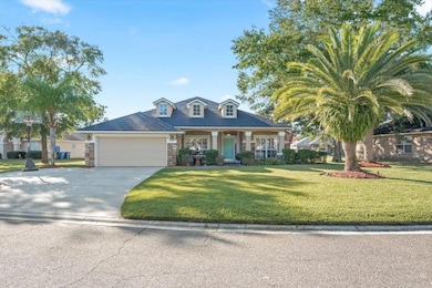 Cape cod house with a porch, a front yard, concrete driveway, and a garage