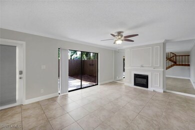 Unfurnished living room with ceiling fan, a textur