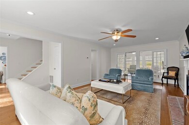 Living room featuring stairs, ornamental molding, 