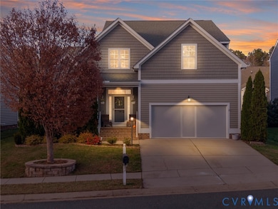 View of front of house featuring a front yard, a porch, driveway, and an attached garage