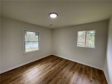Empty room with plenty of natural light, baseboard