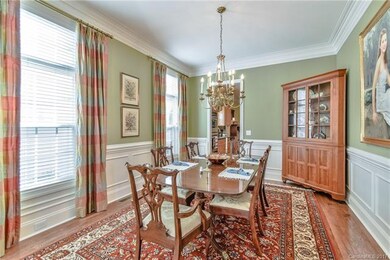 Large, formal dining room with wainscoting and cro
