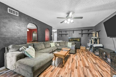 Living area featuring visible vents, arched walkwa