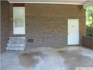 The carport with utility room and door to the kitc