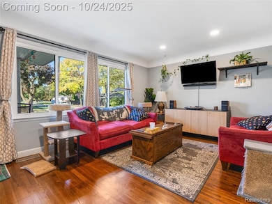 Living room featuring hardwood / wood-style flooring and recessed lighting