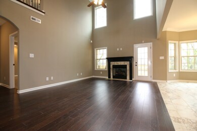 EXAMPLE>>>Large Great Room with Tons of Natural Lighting, Wood Flooring and a Gas Fireplace!!!