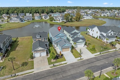 Aerial perspective of suburban area featuring a nearby body of water