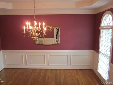 Dining Room w/ hardwood floors, tray ceiling, crow