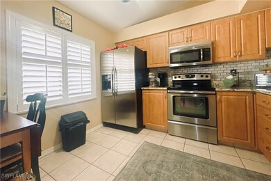 Kitchen featuring light tile patterned floors, bas
