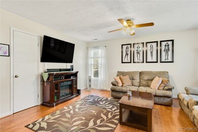 Living room with ceiling fan and light hardwood / wood-style flooring