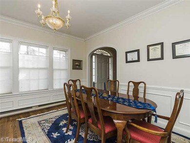 Dining Room. Dining Room off Foyer and Kitchen area.  Decorative Moldings continue in this room with Lighting reminiscent of 1930 s.