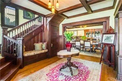 The stunning foyer welcomes you, revealing   the grand staircase, period chandelier and built-in love seat. 