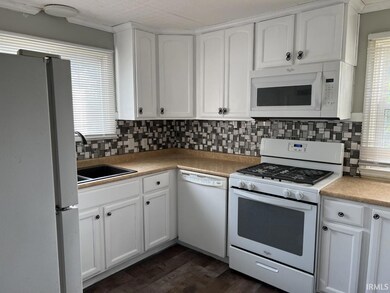 Newly painted white cabinets and new hardware.  Re