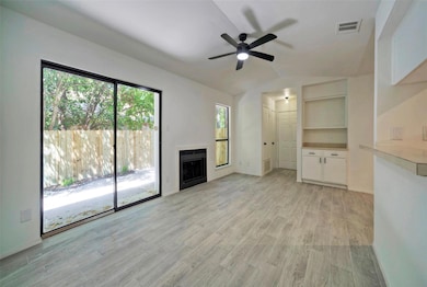 Unfurnished living room with ceiling fan, light w