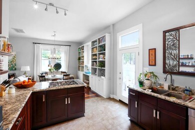Kitchen with new flooring and open to dining / liv