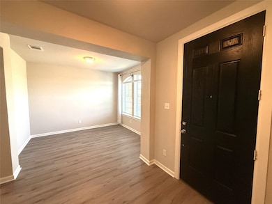 Foyer entrance featuring baseboards and wood finished floors