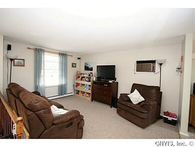 Living Room. Upper living room has berber carpet and built in wall a/c unit.