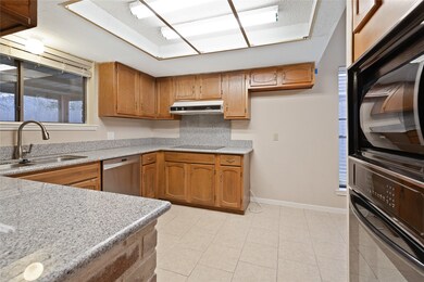 Kitchen area with granite countertops.