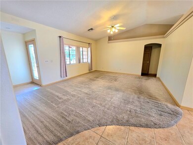 Living room with vaulted cielings and pot shelves