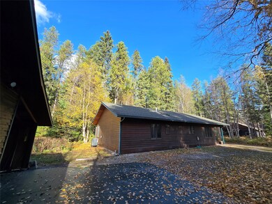 View of side of home with a shingled roof and a cooling unit