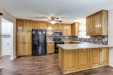 Kitchen featuring kitchen peninsula, ceiling fan, 