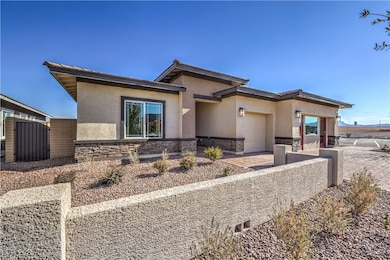 View of front of home featuring stone siding, stuc