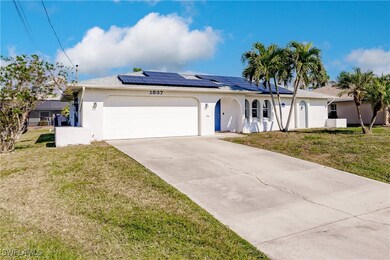 Ranch-style house with a front yard, solar panels,