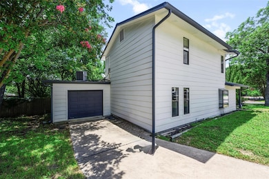 View of home's exterior with concrete driveway an