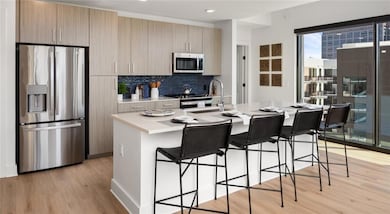 Kitchen with backsplash, light hardwood / wood-sty