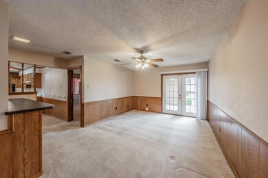 Spare room featuring a wainscoted wall, wooden wal