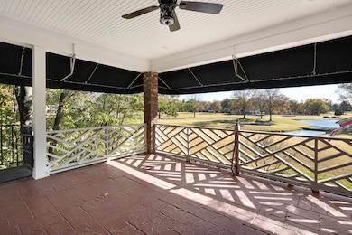 Wooden terrace featuring a water view and ceiling fan