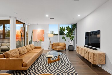 Living room featuring dark wood-style flooring, r