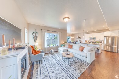 Living area featuring dark wood-style flooring, recessed lighting, and a textured ceiling