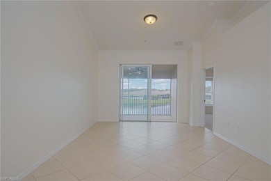 Unfurnished room featuring crown molding, light tile patterned floors, and baseboards