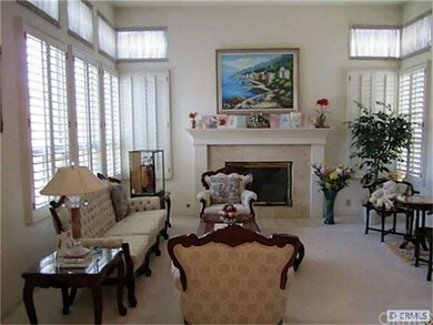 Living room with marble fireplace and high ceiling