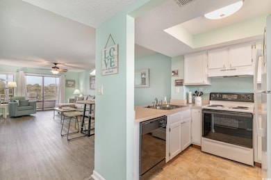 Kitchen with white range with electric stovetop, b