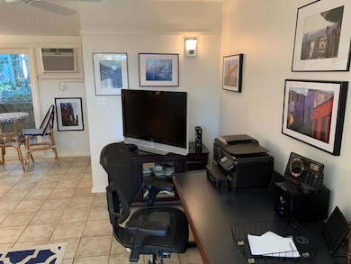 Home office featuring ceiling fan, light tile pat