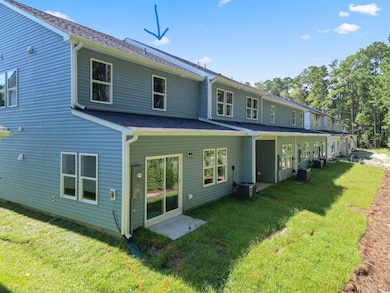 Back of property featuring a lawn and cooling unit