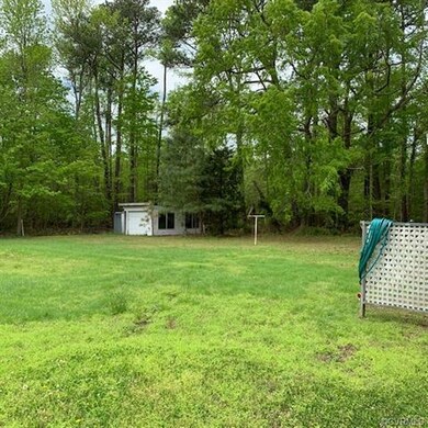 Back corner of property with pole shed and metal s