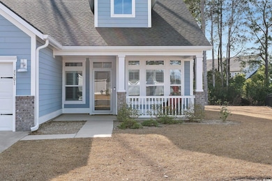 View of exterior entry featuring a shingled roof a