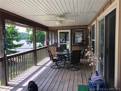 Covered deck looking to screened area. Sliders go