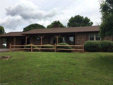Front view of main home. 2 car attached garage has 2nd washer dryer hook up, entry door to kitchen and another to the sun room as well as a small closet for storage.