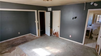 Unfurnished bedroom with baseboards