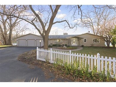 A white picket fence beckons you toward this beaut