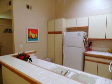 Light, Bright Kitchen with Tile Countertops and Tr