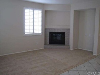 Family room next to kitchen with fireplace.