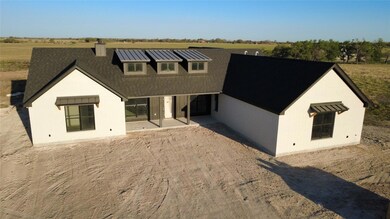 View of front of house with a patio and a chimney