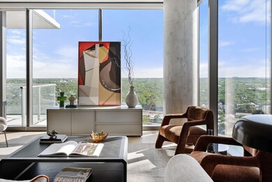 Sitting room with expansive windows and wood fini