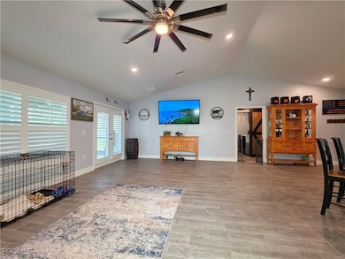 Living area featuring ceiling fan, lofted ceiling,